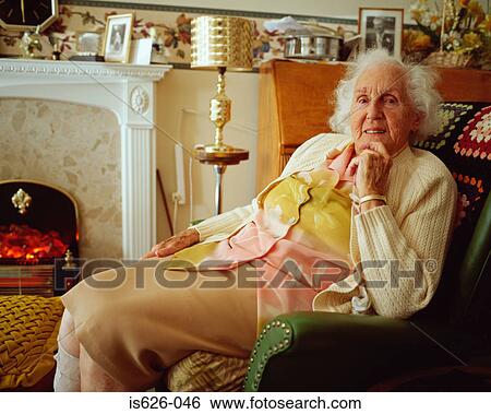 Elderly woman in living room View Large Photo Image Stock Photograph - Elderly woman in living room. Fotosearch
