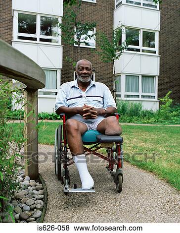 Man in wheelchair in garden View Large Photo Image Stock Photo - Man in wheelchair in garden . Fotosearch