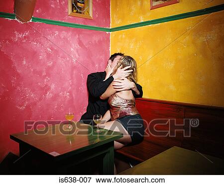 Couple kissing in corner of bar View Large Photo Image Stock Photo - Couple kissing in corner of bar. Fotosearch