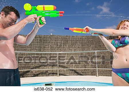 Couple with water pistols View Large Photo Image Stock Image - Couple with water pistols. Fotosearch