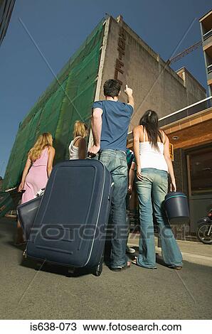 Friends arriving at a hotel View Large Photo Image Stock Image - Friends arriving at a hotel. Fotosearch