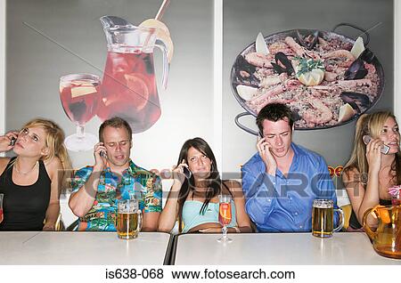 Friends in a bar on mobile phones View Large Photo Image Stock Photo - Friends in a bar on mobile phones. Fotosearch
