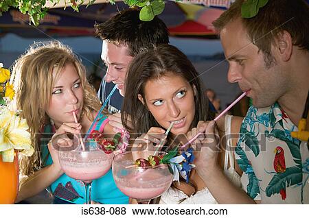 Friends sharing cocktails View Large Photo Image Stock Photo - Friends sharing cocktails. Fotosearch