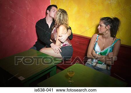 Stock Image - Jealous woman watching couple. Fotosearch