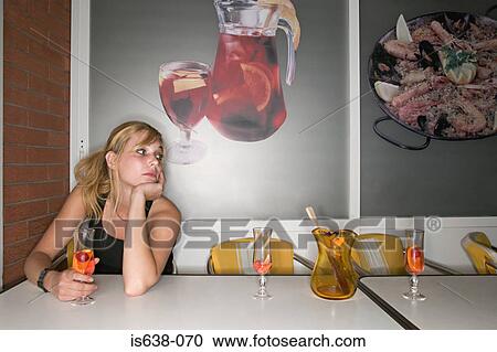 Stock Image - Lonely woman in bar. Fotosearch