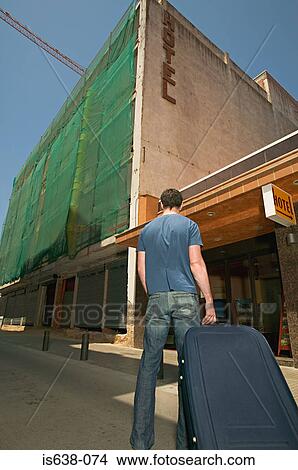 Man arriving at a hotel View Large Photo Image Picture - Man arriving at a hotel. Fotosearch