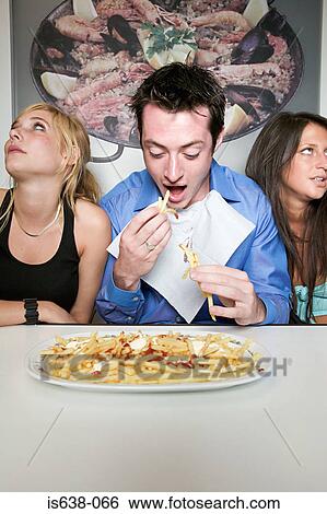 Man eating french fries View Large Photo Image Stock Photograph - Man eating french fries. Fotosearch