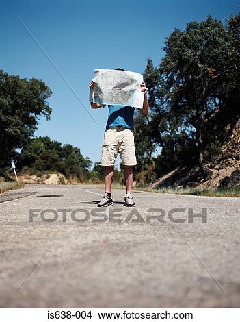 Man holding a road map View Large Photo Image Picture - Man holding a road map. Fotosearch