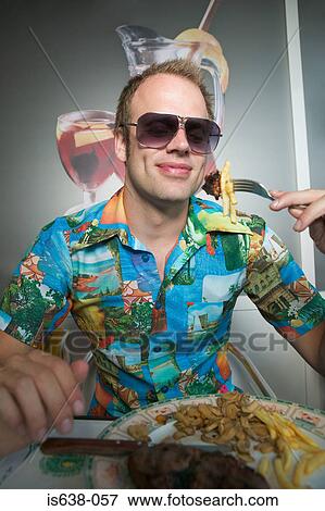 Stock Photo - Man in sunglasses eating meal. Fotosearch