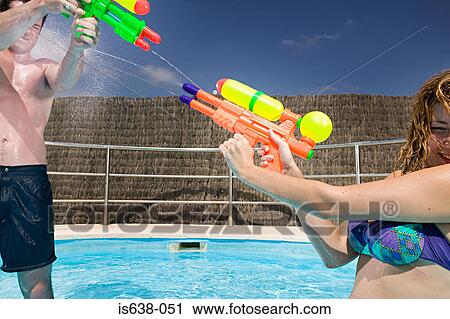 People playing with water pistols View Large Photo Image Stock Image - People playing with water pistols. Fotosearch