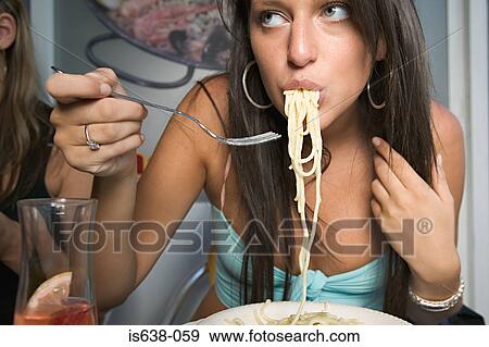 Woman eating spaghetti View Large Photo Image Stock Photo - Woman eating spaghetti. Fotosearch