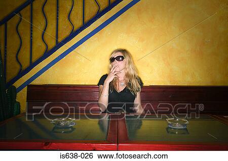 Woman smoking in a bar View Large Photo Image Stock Photograph - Woman smoking in a bar. Fotosearch