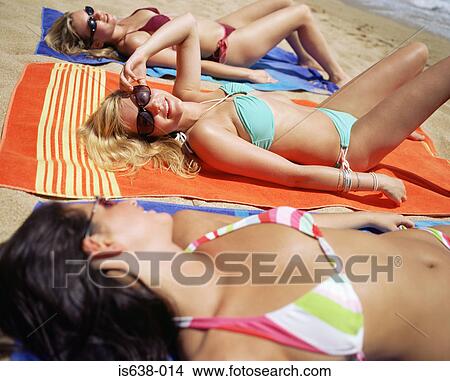 Picture - Women sunbathing on beach. Fotosearch