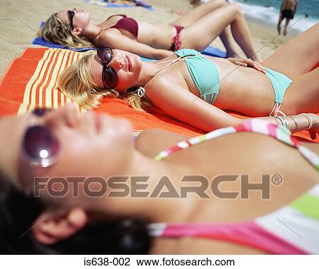 Women sunbathing on beach View Large Photo Image Stock Image - Women sunbathing on beach. Fotosearch