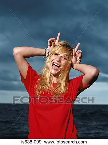 Stock Photo - Young woman making faces. Fotosearch