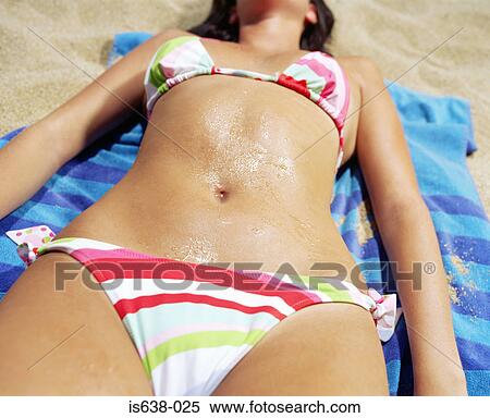 Stock Photography - Young woman sunbathing. Fotosearch