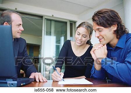 Couple and financial adviser signing paperwork View Large Photo Image Stock Photo - Couple and financial adviser signing paperwork. Fotosearch