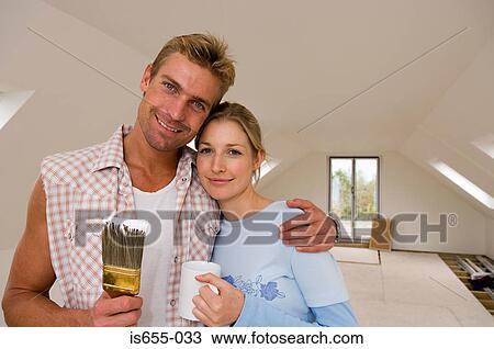 Stock Image - Couple decorating. Fotosearch