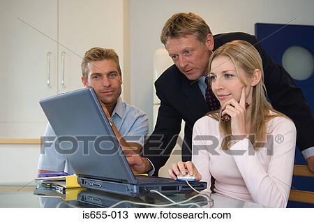 Stock Image - Couple meet with financial adviser. Fotosearch