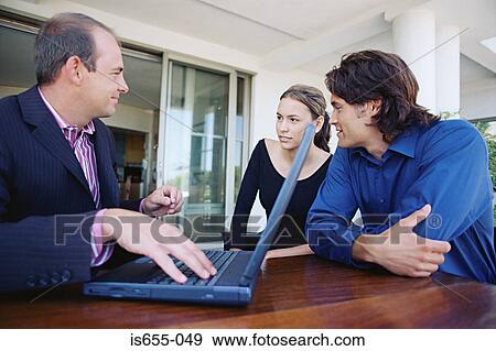 Stock Photo - Couple meeting financial adviser. Fotosearch