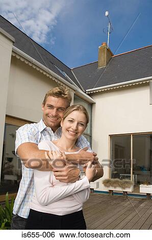 Couple outside their house View Large Photo Image Stock Photograph - Couple outside their house. Fotosearch