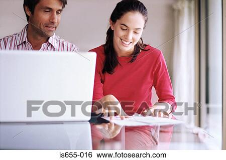 Stock Photograph - Couple sorting out their finances. Fotosearch