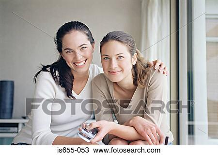Female friends with mobile phone View Large Photo Image Stock Image - Female friends with mobile phone. Fotosearch