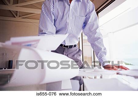 Stock Photograph - Man with paperwork. Fotosearch