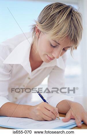 Stock Image - Woman filling in a form. Fotosearch