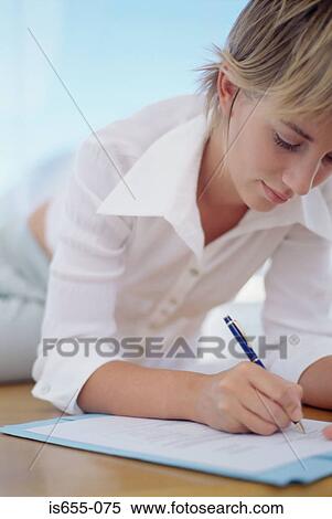 Stock Photography - Woman filling in a form. Fotosearch