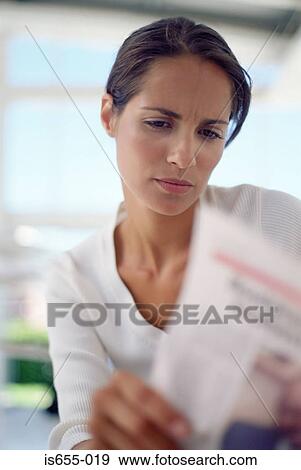 Stock Photo - Woman looking at a bill. Fotosearch