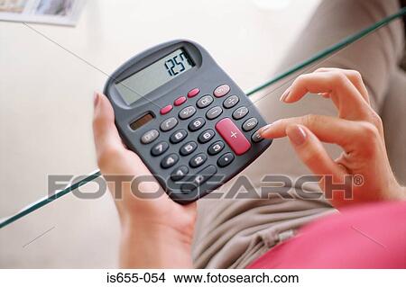 Woman using calculator View Large Photo Image Picture - Woman using calculator. Fotosearch