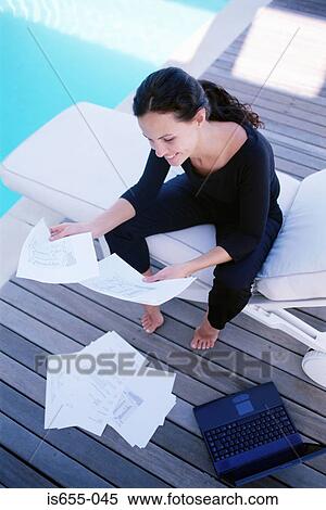 Woman working by the pool View Large Photo Image Stock Photography - Woman working by the pool. Fotosearch