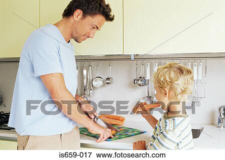 Boy and father preparing carrots View Large Photo Image Stock Photo - Boy and father preparing carrots. Fotosearch