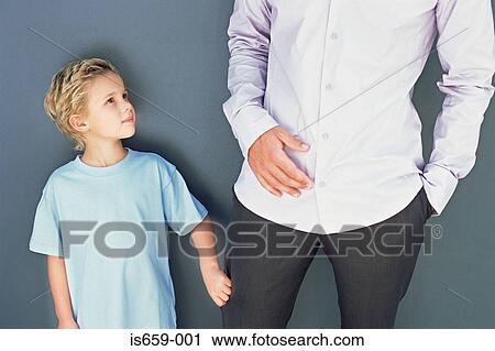 Boy pulling in father's trouser leg View Large Photo Image Stock Image - Boy pulling in father's trouser leg. Fotosearch