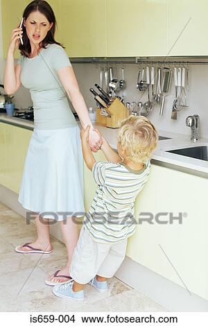 Picture - Boy pulling on mother's arm. Fotosearch