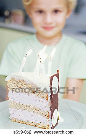 Stock Image - Boy with slice of birthday cake. Fotosearch