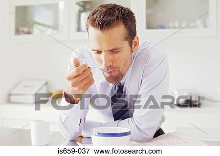 Stock Photo - Businessman having breakfast. Fotosearch