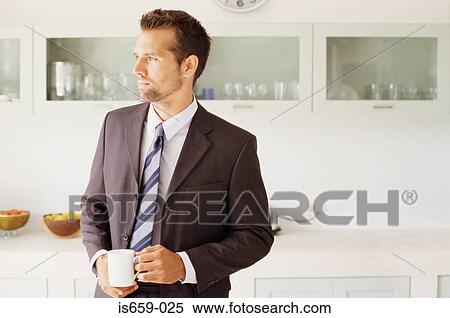 Businessman in the kitchen View Large Photo Image Stock Photography - Businessman in the kitchen. Fotosearch