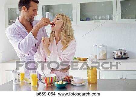 Couple sharing breakfast View Large Photo Image Picture - Couple sharing breakfast. Fotosearch