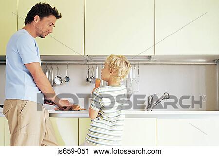 Father and son preparing carrots View Large Photo Image Stock Image - Father and son preparing carrots. Fotosearch