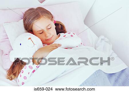 Girl asleep in her bed View Large Photo Image Picture - Girl asleep in her bed. Fotosearch