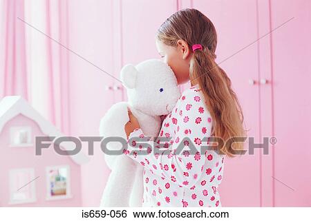 Girl hugging her teddy bear View Large Photo Image Stock Photograph - Girl hugging her teddy bear. Fotosearch