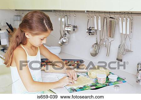 Girl making biscuits View Large Photo Image Stock Photo - Girl making biscuits. Fotosearch