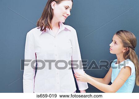 Stock Photo - Girl pulling on mother's arm. Fotosearch