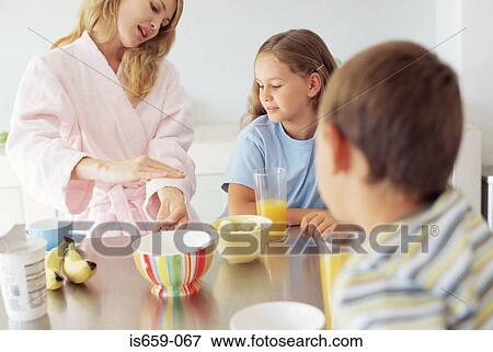 Mother and children having breakfast View Large Photo Image Stock Photo - Mother and children having breakfast. Fotosearch