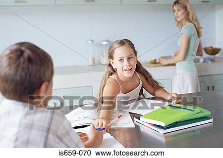 Mother watching children doing homework View Large Photo Image Stock Image - Mother watching children doing homework. Fotosearch