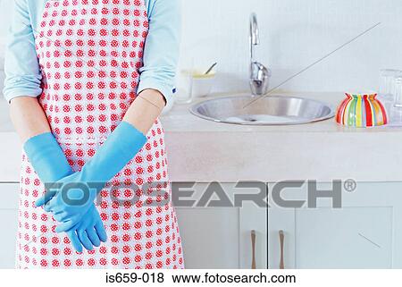 Woman by the kitchen sink View Large Photo Image Stock Photo - Woman by the kitchen sink. Fotosearch