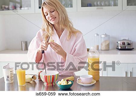 Stock Photo - Woman preparing a healthy breakfast. Fotosearch