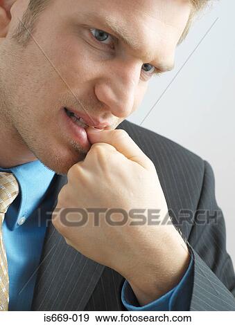 Stock Photo - Businessman biting his nails. Fotosearch